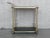 Fabulous brass bar cart with smoked glass Proudly showcase your finest decanters and stemware! Brass handle. This piece is...