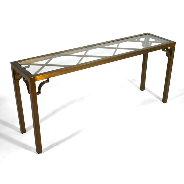 This console table by Mastercraft features a simple parsons table form that is nicely detailed with a diamond lattice...