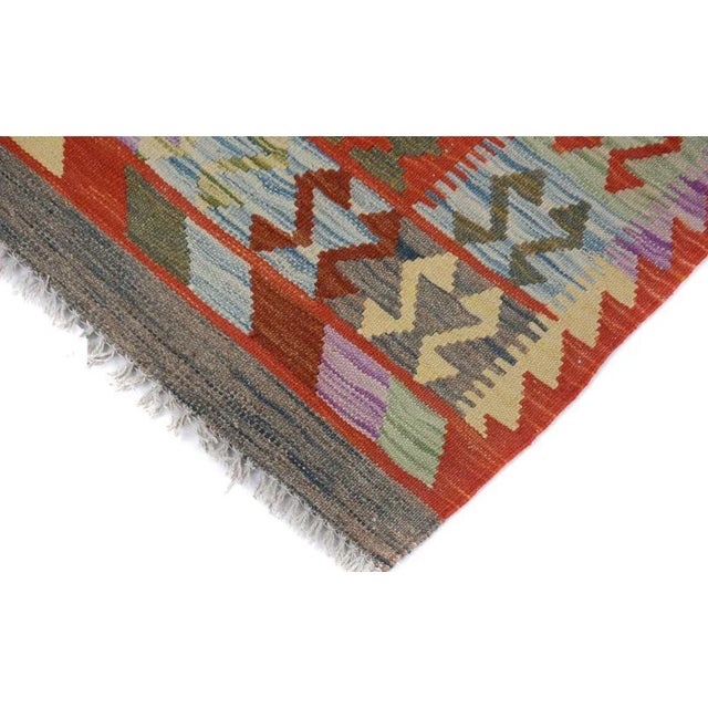 Add a touch of elegance to your home with this casual chic hand woven Tribal Kilim wool rug. Constructed on a loom by...