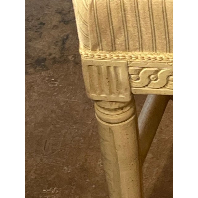 This set of 4 Swedish carved and painted side chairs from the late 19th century exudes elegant craftsmanship. The...