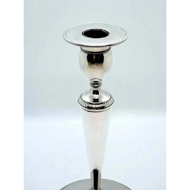 Pair of elegant Empire candleholders on an unfilled base, conical structure, offset olive-shaped grommets with a flat,...