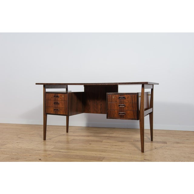 Free-standing Danish desk from the 1960s, designed by Gunnar Nielsen Tibergaard. It is an excellent example of timeless...