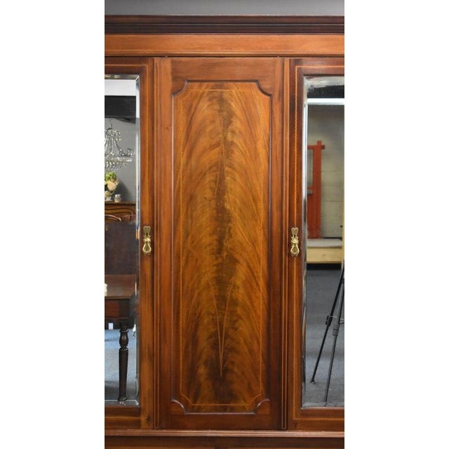Edwardian Mahogany Triple Wardrobe with Mirrored Doors Item Code: LC1415 A handsome Edwardian mahogany triple wardrobe of...