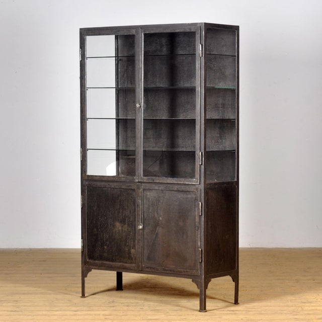 Medical cabinet from the 1930s, made in Hungary. This cabinet is made of iron and glass, creating a robust industrial...