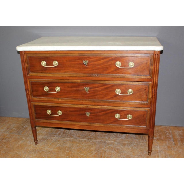 Small Louis XVI chest of drawers in cherry wood, it opens with three drawers, original bronze, original white marble top,...