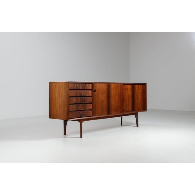 Stunning and rare sideboard by Erik Buch, produced by Oddense Møbler in Denmark in the 1960s. It is a refined example of...