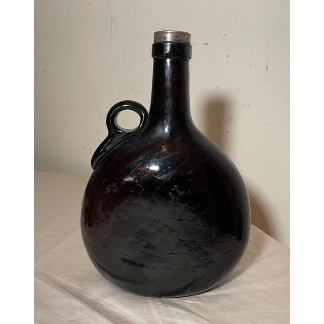 Experience the charm of the 19th century with this antique hand-blown deep ruby red colored glass liquor flask. The dark...