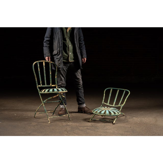 Matched pair of painted metal folding garden chairs by François Carré, featuring the maker's iconic sunburst (also known...