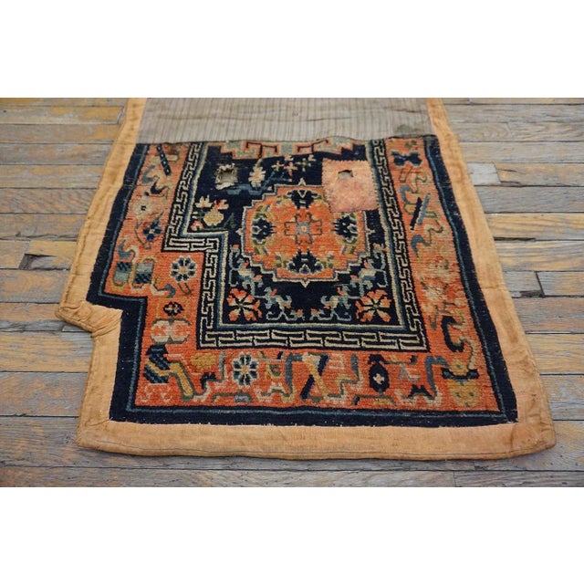 Antique Chinese horse cover, size: 2'2" x 4'4". This early 20th-century Chinese rug saddle or horse cover is a rare and...