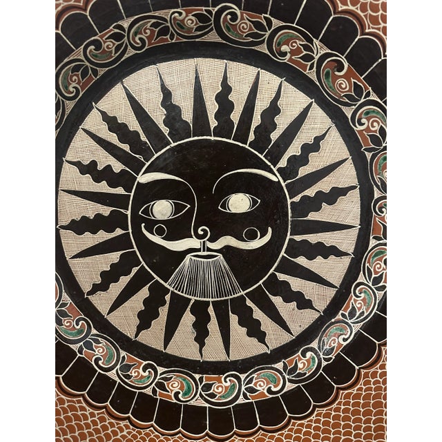 Intricately painted, vintage, folk art plate from Tonala, Mexico. A fantastic, whimsical male sun is centrally set to...