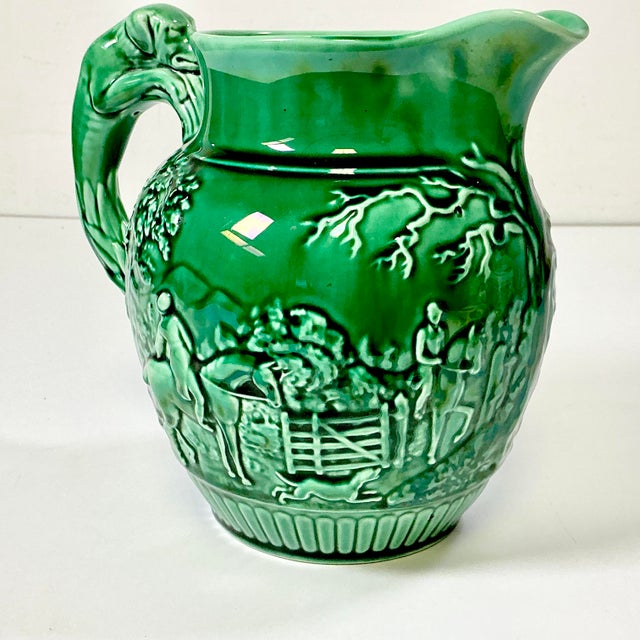This is a vintage English Wedgwood Majolica Pitcher. It features a Hound Hunting motif including a dog on the handle, all...
