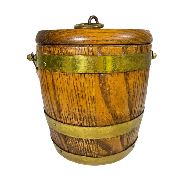 Charming vintage wood ice bucket with a beautifully aged brass finish, evoking the relaxed elegance of an English country...