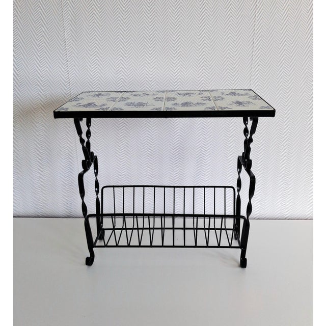 Vintage side table or magazine rack featuring a charming Delft-style ceramic tile top with traditional cobalt blue Dutch...