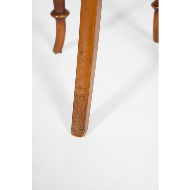 A beautifully proportioned early 20th-century chair from Italy featuring an elegant curved backrest and a warm walnut...
