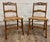 This is a stunning pair of antique carved walnut ladder back cane seat dining chairs or occasional chairs with carved...