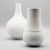 White porcelain vase duo designed by Bjørn Wiinblad for Rosenthal Studio-Line in 1967–68. Both pieces combine a smooth,...
