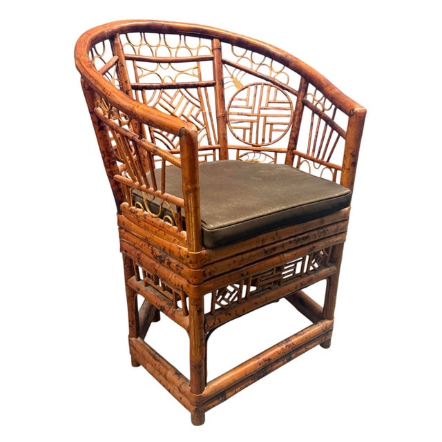 A vintage rattan Brighton Pavilion chair. Horseshoe shape. Intricate tortoise rattan fretwork design to front and...