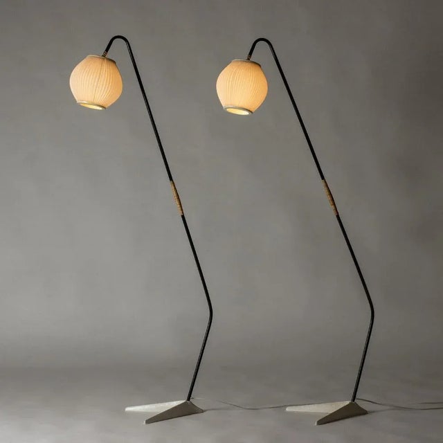 Pair of striking floor lamps by Svend Aage Holm Sørensen, made from black lacquered metal with sculpted v-shaped bases....