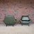 A striking pair of sculptural mid-century modern lounge chairs featuring dramatic winged forms and low, architectural...