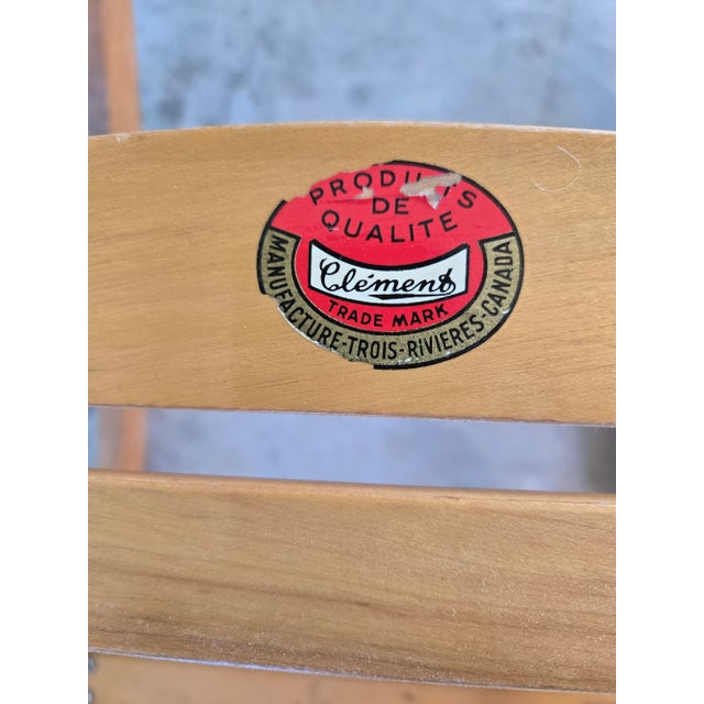 A vintage folding rocking chair by Les Freres Clement (Clement Brothers) of Quebec. The chair is solid maple and it folds...