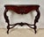 Elegant early 20th century console table crafted in richly carved wood with a beautifully shaped silhouette. The piece...
