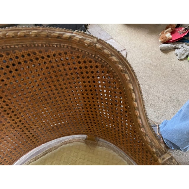 Step into timeless refinement with this gilded Bergère chair, a post‑war revival of the Louis XV style. Its hand‑carved...