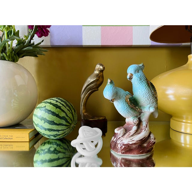 This brass parrot features a sleek, stylized form with graceful curves. Its warm, golden finish and tropical-inspired...
