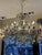 A most charming italian 19th century pressed patinated metal, giltwood and crystal twelve lights genovese chandelier. This...