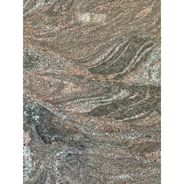 Custom Granite dining table with 50 inch knife edge top and custom ribbed-cut cylinder base. The movement and pattern of...