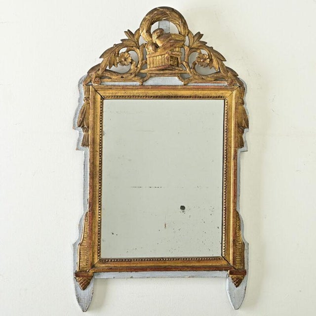Dimensions: 35 ⅜” H x 20 ¾” W x 1 ¼” D An eye-catching French mirror, Louis XVI period (18th century). The painted and...