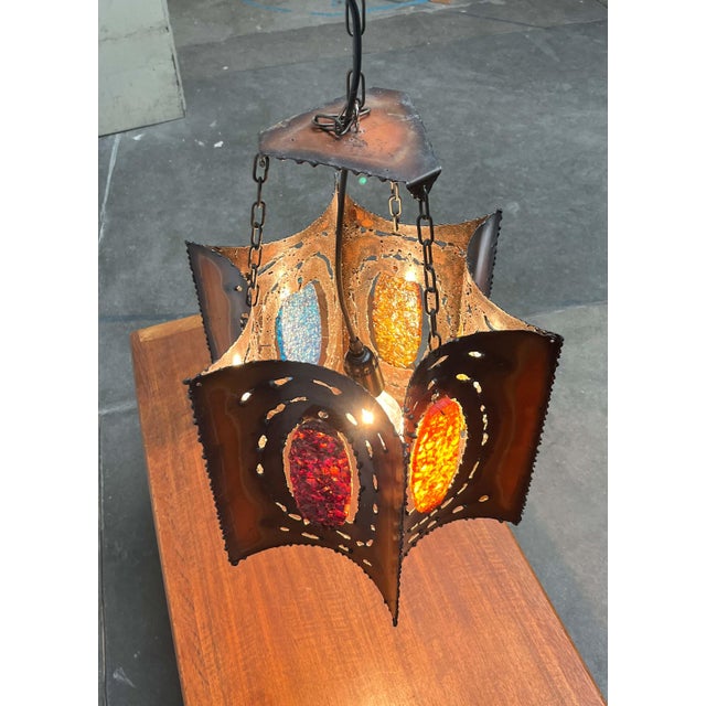 An imposing pendant lamp in a brutalist style by accolay of france. the lamp consists of six concave copper sheets...