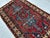 This antique hand-knotted Lori Pambak Kazak rug features a monumental stepped cruciform medallion in slate blue, anchored...