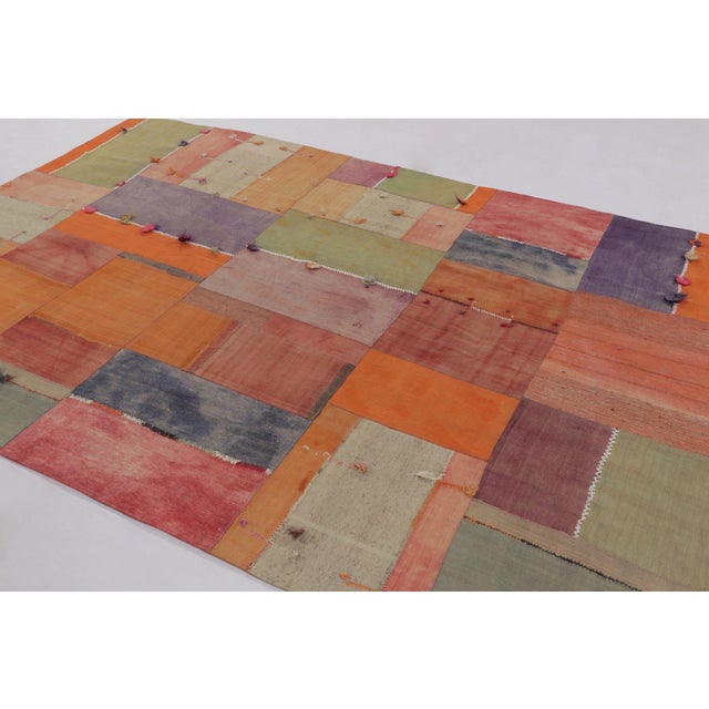 Handwoven in cotton and wool, this 7x10 vintage Turkish patchwork rug, circa 1950-1960, is a striking example of mid-...