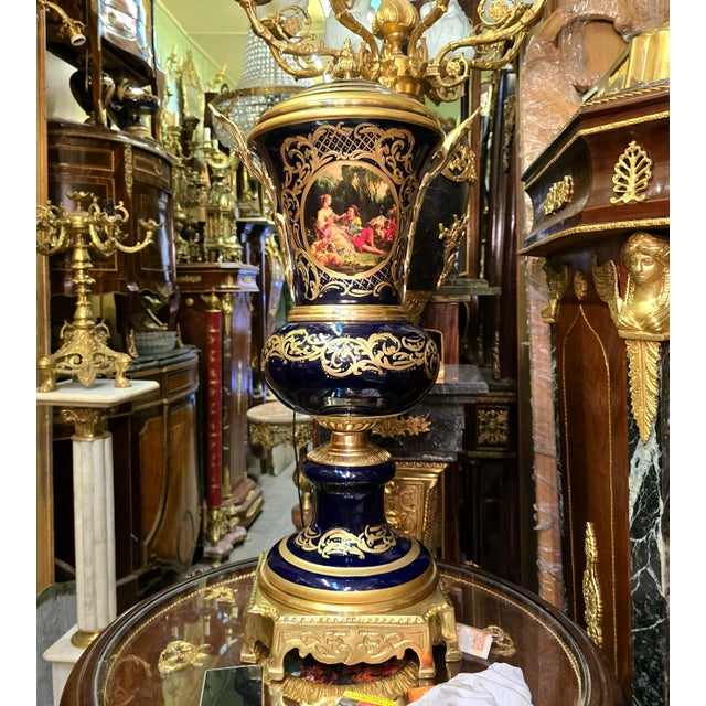 Elevate an elegant interior with this unique French-style decorative porcelain urn, featuring a striking deep navy blue...