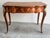Rococo-style marquetry inlaid desk with floral motifs and featuring rich marquetry inlay and ornate gilt bronze (ormolu)...