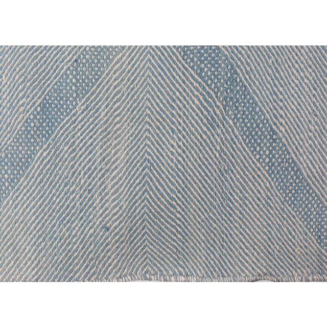 This Modern Moroccan Geometric Wool Rug is a sophisticated flat-weave textile that balances artisanal craftsmanship with...