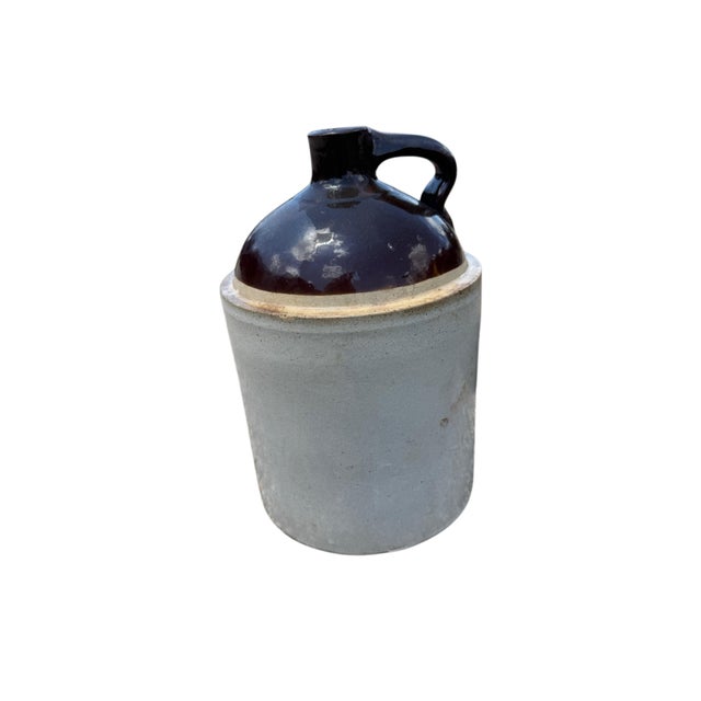 A handsome and authentic American stoneware storage jug dating to the late 19th century, featuring a classic off-...