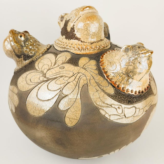 This is a fabulous and fantastical large covered pot by renowned Raku potter Randy Brodnax. It features frog heads all...
