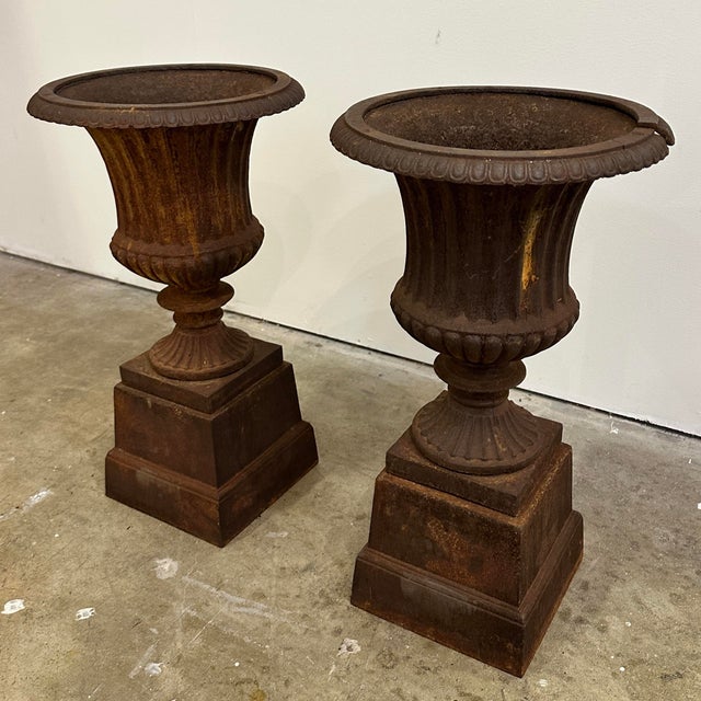 A pair of mid 20th century made cast Iron planters on stand Naturally weathered finish See photos for details One of the...