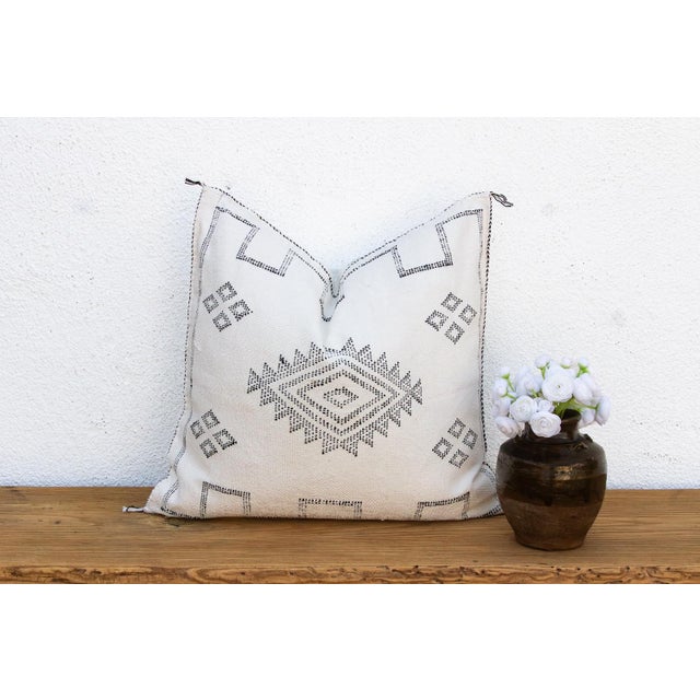Make a graphic statement with this handcrafted Moroccan cactus silk pillow, measuring approximately 24 inches square....