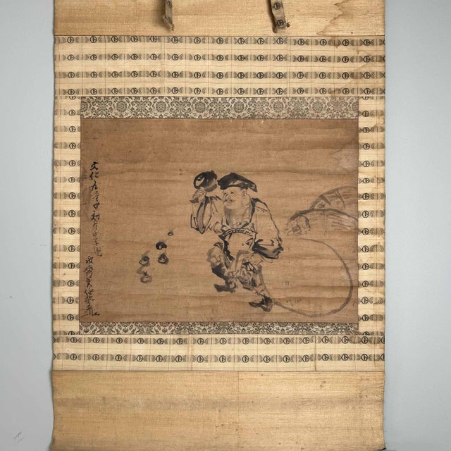 Antique Japanese scroll or kakemono with the image of Daikokuten. Size: 111 cm x 58 cm. The drawing and calligraphy are...