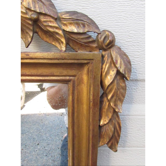 Antique Italian neoclassical giltwood mirror, c.1900 Having a central urn to the pediment with flowers and flowing...