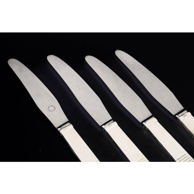 Georg Jensen, set of four Parellel lunch knives. Set of four lunch knives in stainless steel and sterling silver in the...