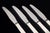 Georg Jensen, set of four Parellel lunch knives. Set of four lunch knives in stainless steel and sterling silver in the...