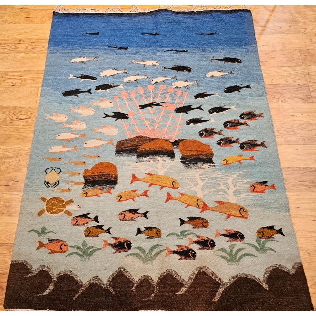 A striking vintage hand-woven flat-weave kilim rug from the mid-20th century, beautifully designed in the mid-century...