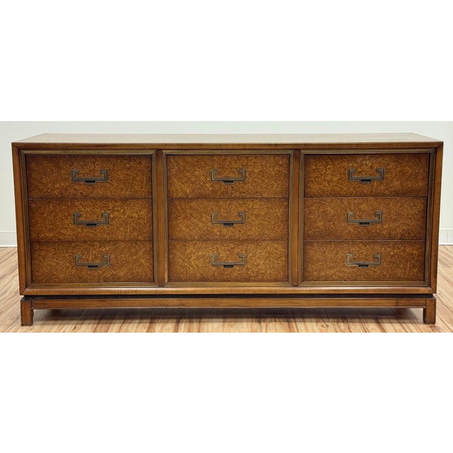 Stunning Mid Century Modern burled wood nine (9) drawer lowboy dresser with brass campaign hardware. Features brass frames...