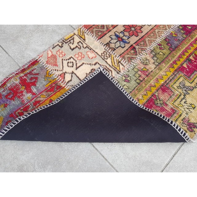 This is a vintage Turkish Oushak rug from the Mid 20th Century. The piece was hand-knotted.