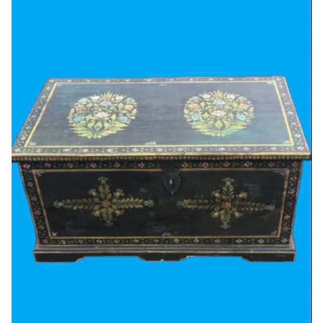 Exquisite hand painted ornate trunk adorned in captivating green, yellow, pink and red colors. This trunk is stylish the...