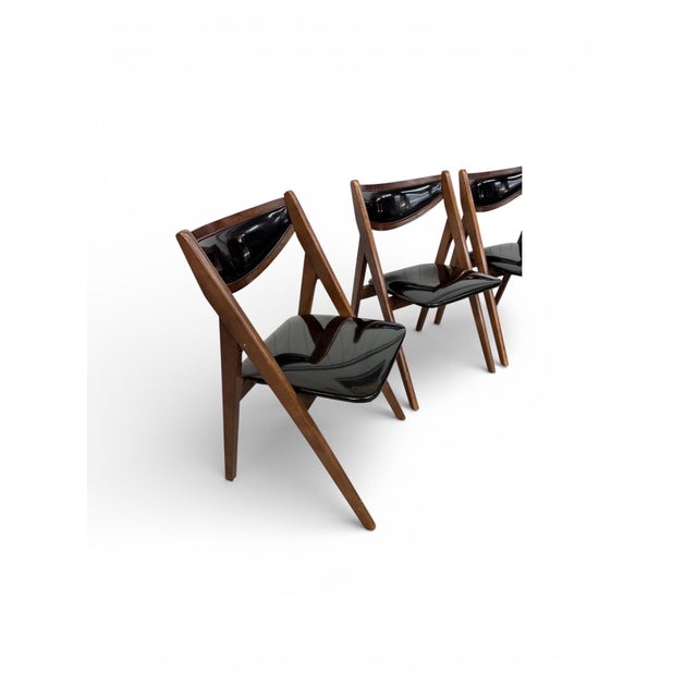 This elegant set of four Mid-Century Modern Stakmore folding dining chairs perfectly blends form, function, and timeless...