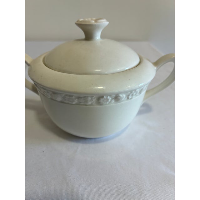 A vintage covered sugar bowl by Wedgwood & Co. Ltd. in the Hedge Rose pattern. Made in England and dated 7-65, the creamy...